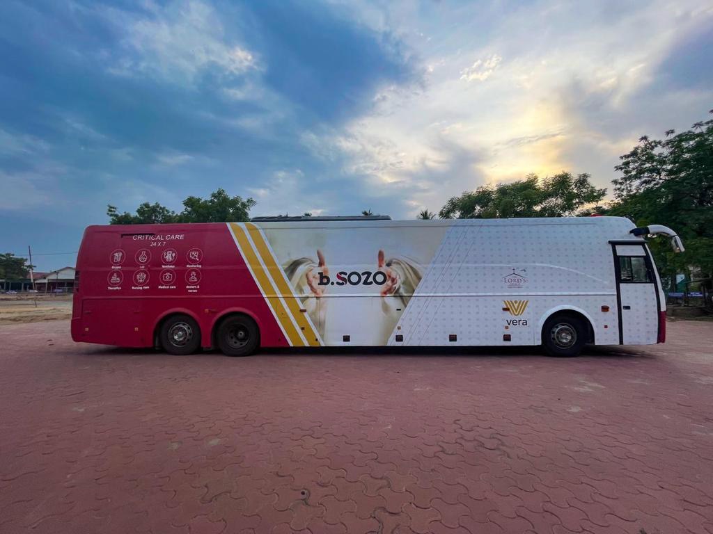 Side view of a b.SOZO Critical Care 24x7 mobile ICU coach with Vera logo and Lord's Church branding parked at deployment site